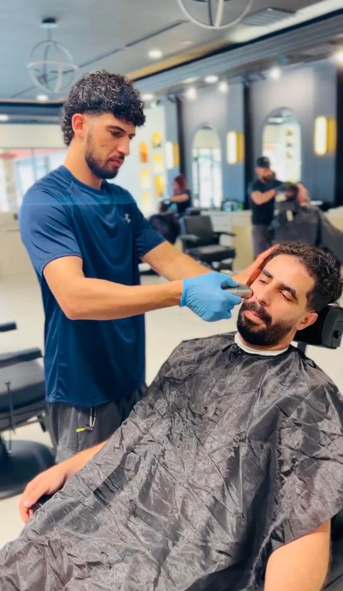 Barber performing a precision grooming service at Jad Cutz